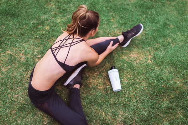 Woman stretching on grass